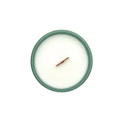 Top view of a natural scented candle in a hunter green matt ceramic vessel, produced for the product line of a European brand